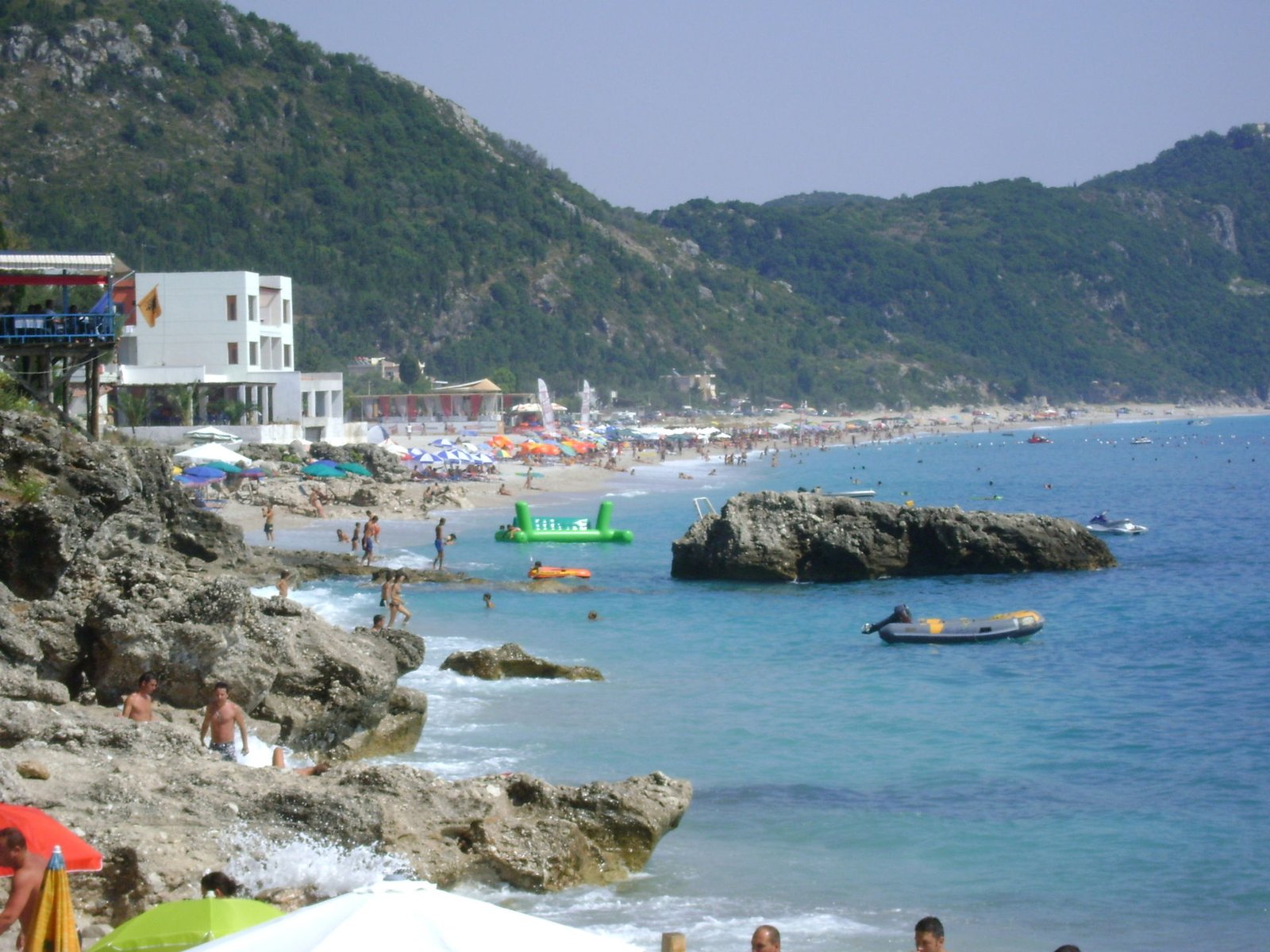 Dhermi beach, Albania — rocky shoreline with mountains and clear water