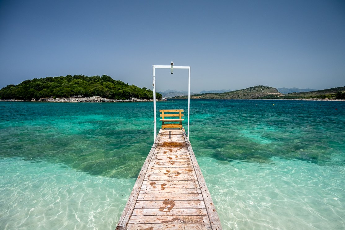 Ksamil beach, Albania — iconic wooden pier over crystal clear turquoise water
